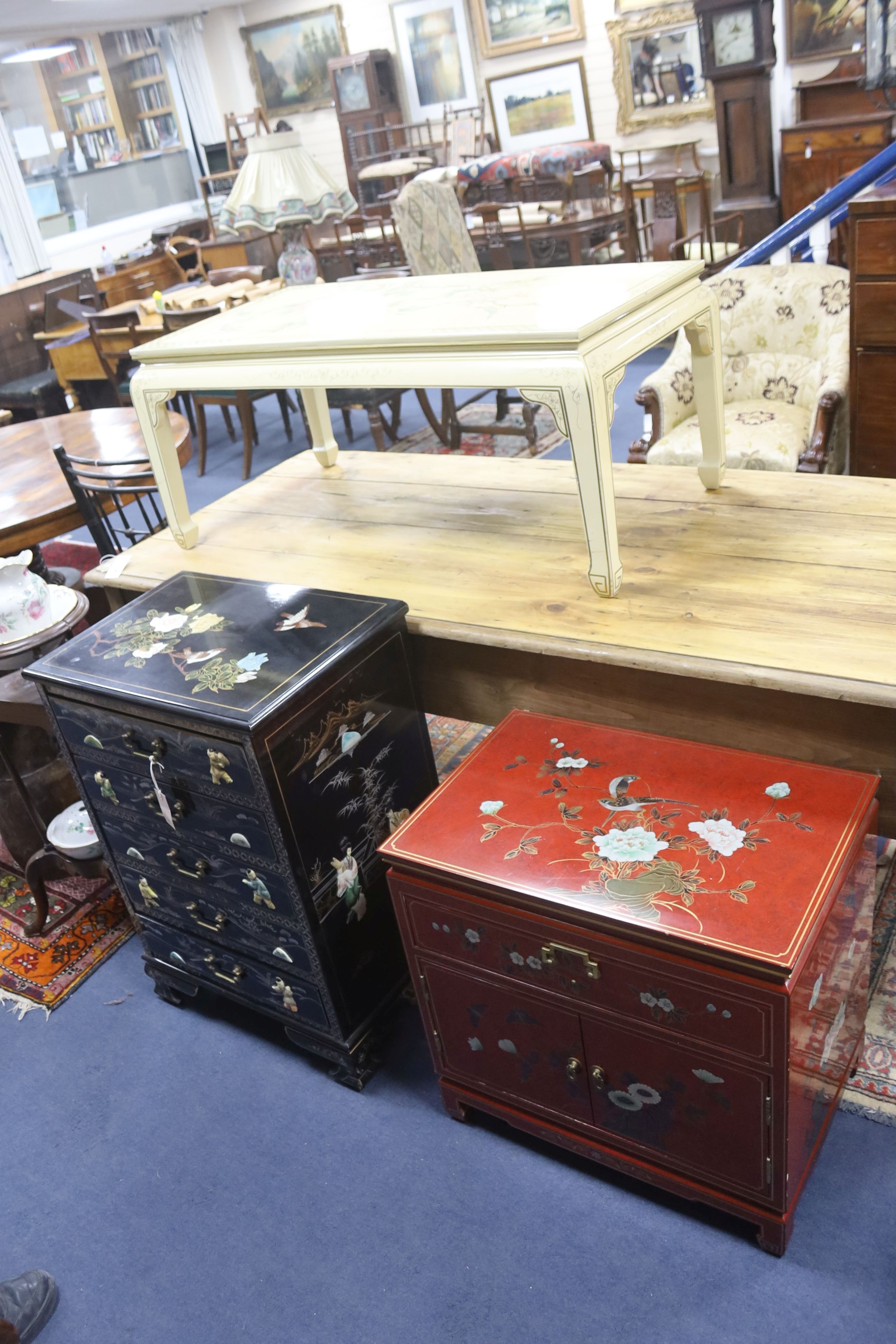 A Chinese black laquer chest of five drawers, a red lacquer chest and a cream lacquer coffee table